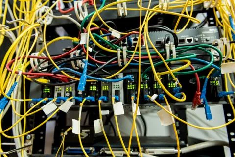 Server room with computers for internet. Network cables connected to switches. Stock Photos