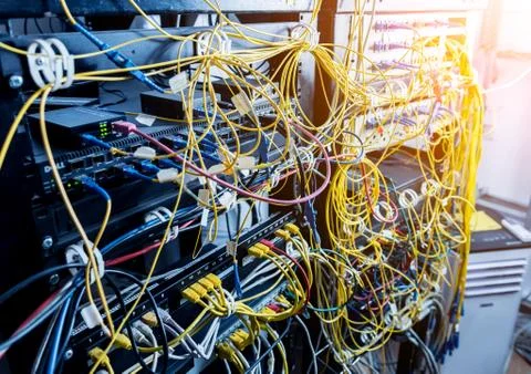 Server room with computers for internet. Network cables connected to switches. Stock Photos