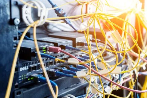 Server room with computers for internet. Network cables connected to switches. Stock Photos
