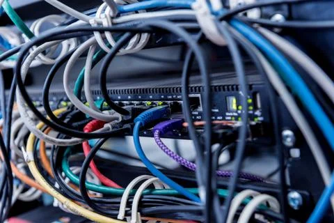 Server room with computers for internet. Network cables connected to switches. Stock Photos
