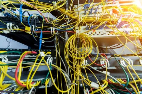 Server room with computers for internet. Network cables connected to switches. Stock Photos