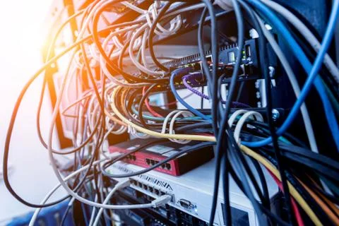 Server room with computers for internet. Network cables connected to switches. Stock Photos