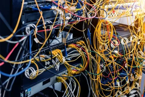 Server room with computers for internet. Network cables connected to switches. Stock Photos