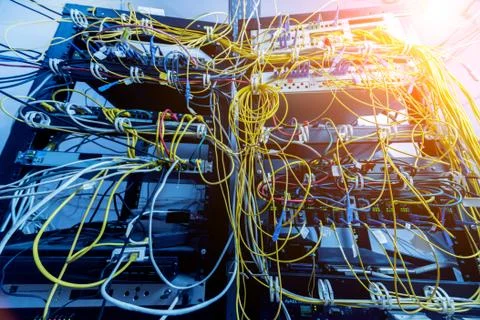 Server room with computers for internet. Network cables connected to switches. Stock Photos