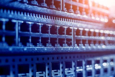 Server room with computers for internet. Network cables connected to switches. Stock Photos