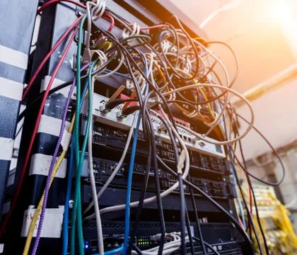 Server room with computers for internet. Network cables connected to switches. Stock Photos