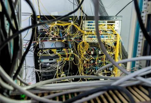 Server room with computers for internet. Network cables connected to switches. Stock Photos