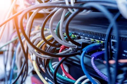Server room with computers for internet. Network cables connected to switches. Stock Photos