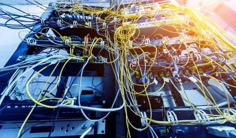 Server room with computers for internet. Network cables connected to switches. Stock Photos