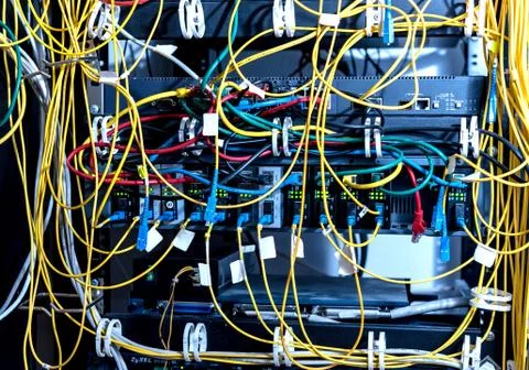 Server room with computers for internet. Network cables connected to switches. Stock Photos