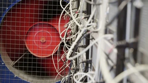 Server room for crypto currency mining farms with huge rotating red cooler. Stock Footage 106219294