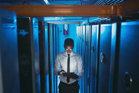 Server room, dark and black man on tablet for network system, diagnostics and Foto stock
