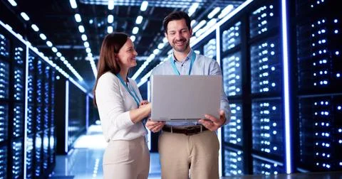 Server Room In Data Center. Cloud Computer Engineers Configuring AI Technolog Stock Photos