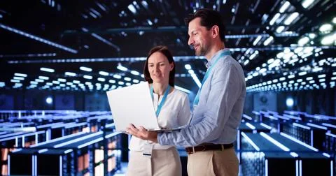 Server Room In Data Center. Cloud Computer Engineers Configuring AI Technolog Stock Photos