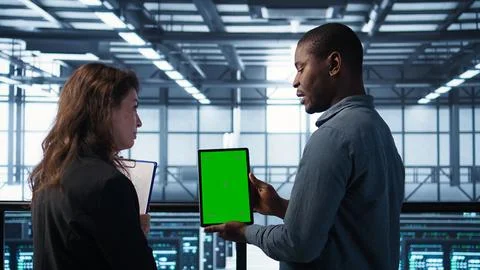 Server room data scientists using mockup tablet, conducting security audits Stock Photos