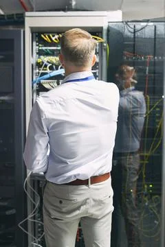 Server room, engineer and back with inspection for cybersecurity, maintenance or Foto stock