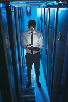 Server room, engineer and black man on tablet for hardware, diagnostics and Stock Photos