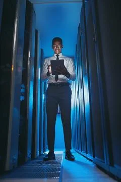 Server room, engineer and black man on tablet for diagnostics, cybersecurity and Stock Photos