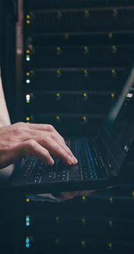 Server room, engineer and hands with laptop, coding or network engineering with Stock Photos