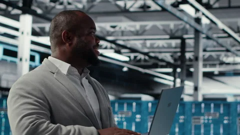 Server room engineer deploying new builds to improve uptime using software Stock Footage 311833179