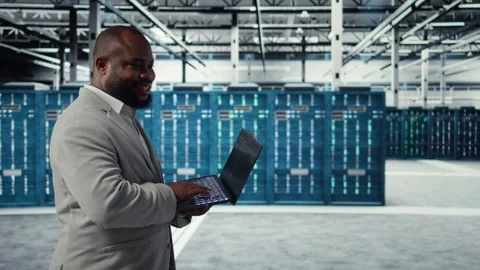 Server room engineer deploying new builds to improve uptime using software Stock Footage 311833555