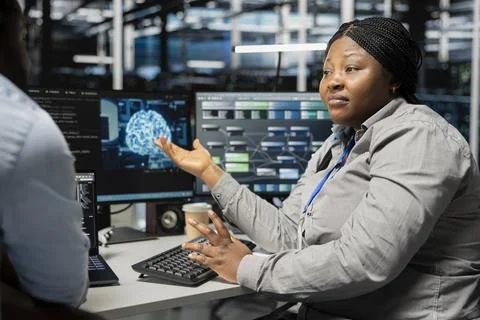 Server room engineering team doing brainstorming, using artificial intelligence Stock Photos