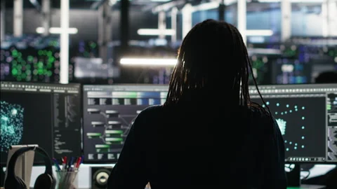 Server room expert interpreting AI data analytics graphs, putting on headphones Stock Footage 307021864