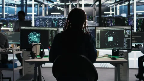 Server room expert interpreting AI data analytics graphs, putting on headphones Stock Footage 307040202