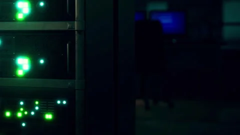 Server room with green lights and a computer visible in the background 動画素材 345003529