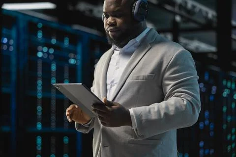 Server room IT professional doing infrastructure scans, fixing network issues Stock Photos