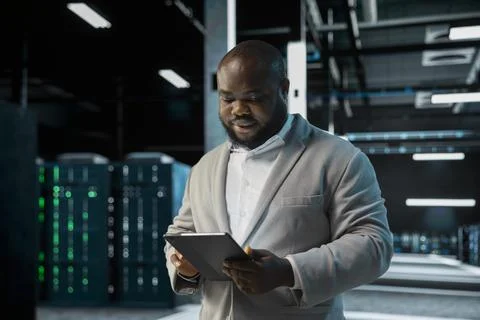 Server room IT professional doing infrastructure scans, fixing network issues Stock Photos