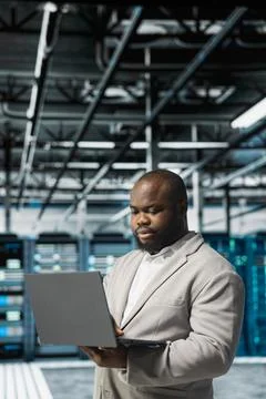 Server room IT specialist doing gear scans, fixing network issues affecting rigs Stock Photos