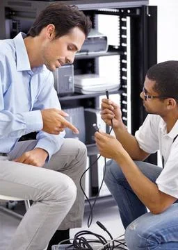 Server room, it support and cable maintenance with a technician talking to a Stock Photos
