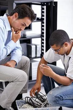 Server room, it support and cable management with a technician talking to a Stock Photos