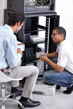 Server room, it support and maintenance with an engineer talking to a business Foto stock