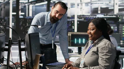 Server room manager providing feedback to employee managing AI datasets 스톡 동영상 309633543
