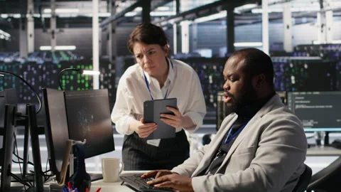 Server room manager supervising technician examining deep learning algorithms Stock-Footage 309638438