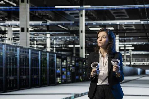 Server room manager using VR equipment to do maintenance on rigs Stock Photos