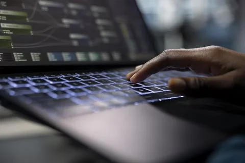 Server room programmer coding on laptop, typing on keyboard, close up Stock-Fotos