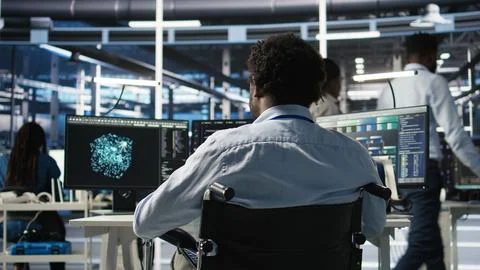 Server room programmer with paraplegia interprets AI data analytics graphs Stock Photos