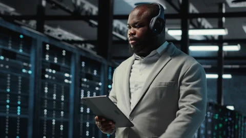 Server room programmer wearing headphones troubleshooting errors Stock-Footage 311833672