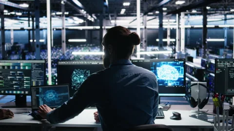 Server room software developer using AI to review infrastructure diagnostics Stockbeeldmateriaal 313569052