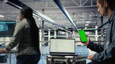 Server room software developer using mockup phone Stock Footage 314804475