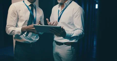 Server room, tablet and hands of people for database backup, IT support and Stock Photos