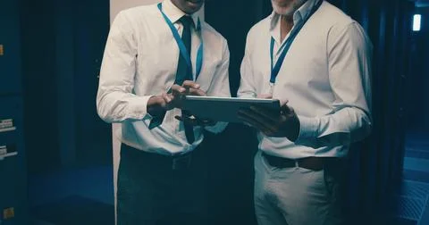 Server room, tablet and hands of people for IT support, database backup and Stock Photos