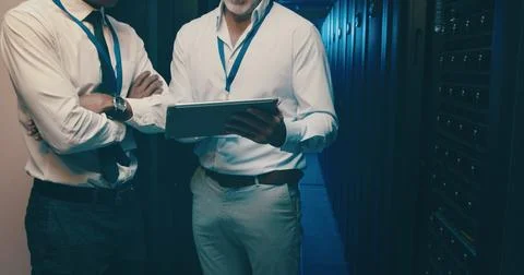 Server room, tablet and hands of men for IT support, database backup and Stock Photos