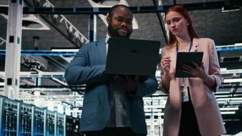 Server room teamworking colleagues using tablet and laptop Stock Footage 330089346