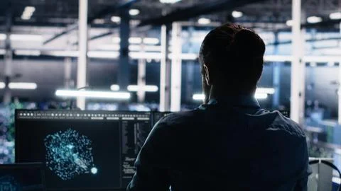 Server room technician stretching sore back while using AI at desk Stock Photos