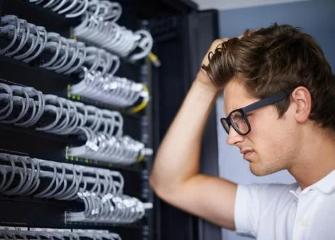 Server room, thinking and confused man with cables for connectivity, night and 写真素材