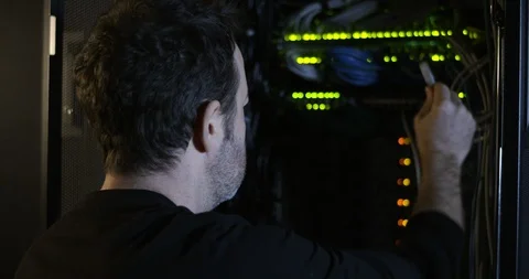 Server Room Worker Plugging in Cable Over The Shoulder Stock Footage 101501929